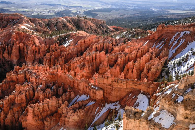 A stunning aerial view of Bryce Canyon's striking hoodoos with snow patches, showcasing natural beauty.
