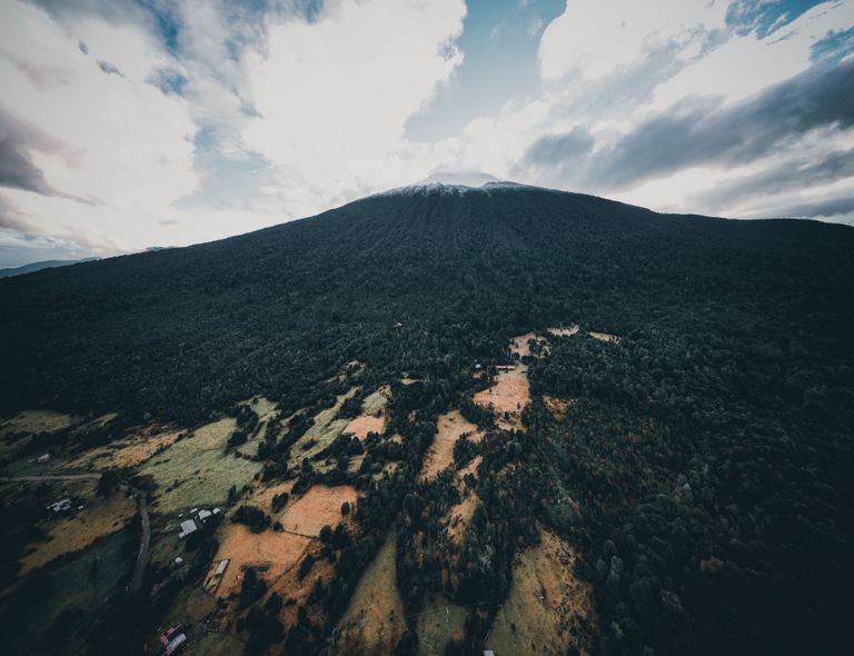 Drone view of Hornopirén Volcano, showcasing lush forests and scenic landscapes in Los Lagos, Chile.