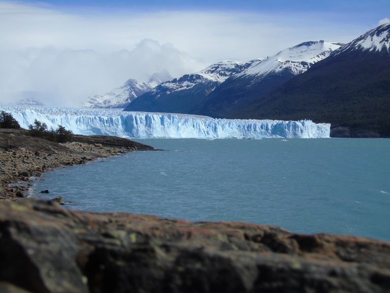 Breathtaking view of Perito Moreno Glacier with snowy mountains and blue lake in a winter landscape.