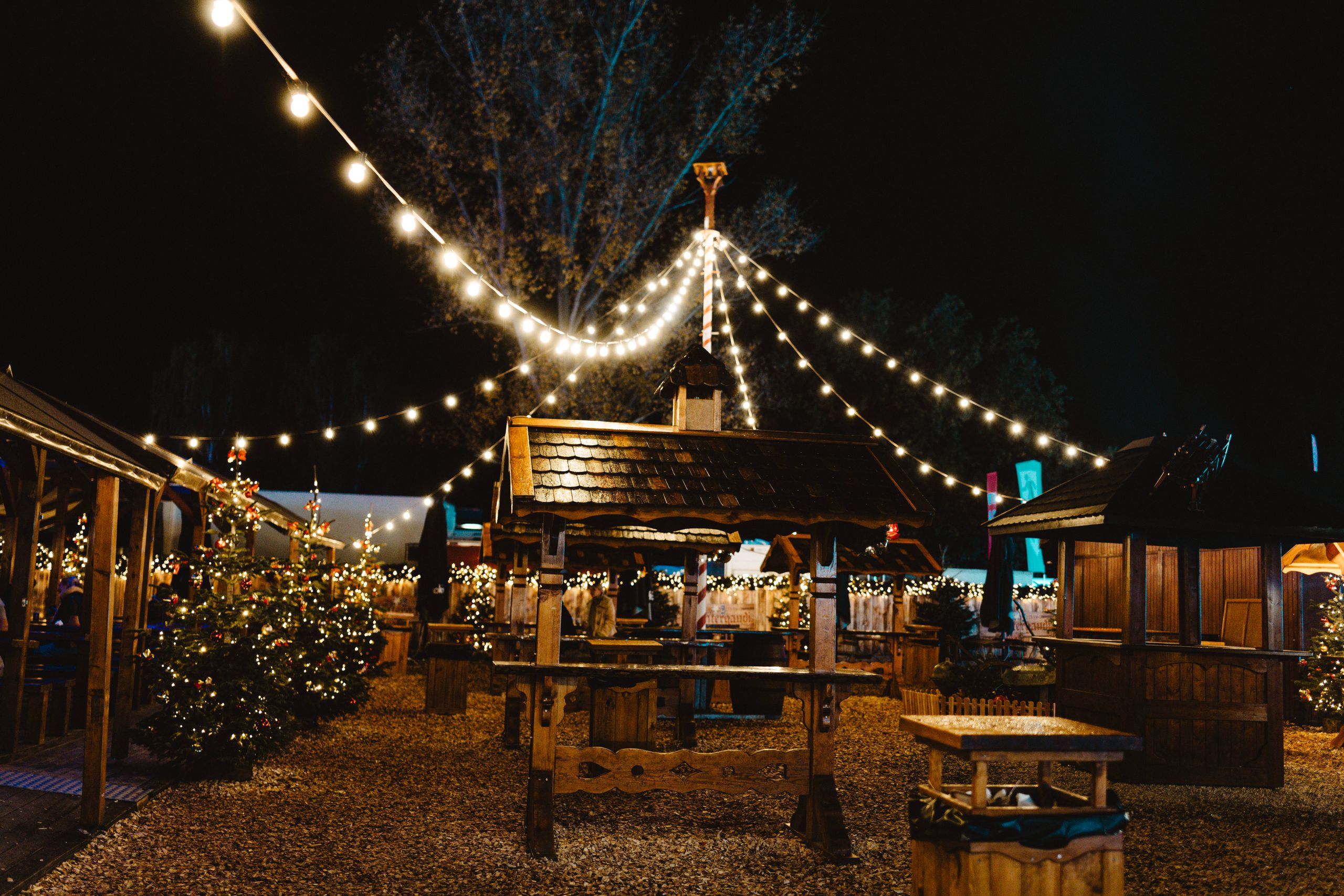 Enchanting Berlin Christmas market illuminated at night with festive decorations and lights.